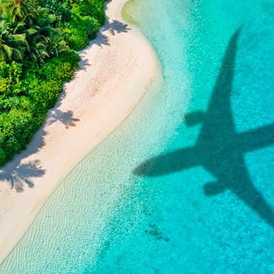 The shadow of an airplane reflected on a beach.