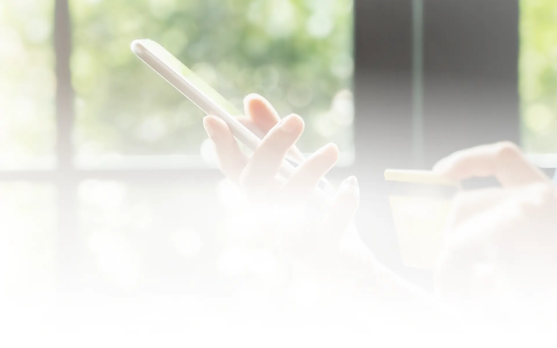 A woman holding a mobile and a card in her hands.